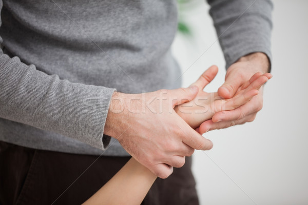 Masseur massaging the hand of  a woman in room Stock photo © wavebreak_media