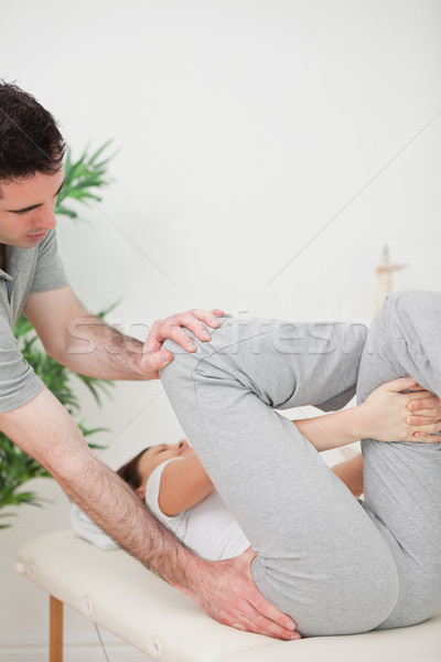 Close-up of a physiotherapist helping a woman for her exercise in a room Stock photo © wavebreak_media