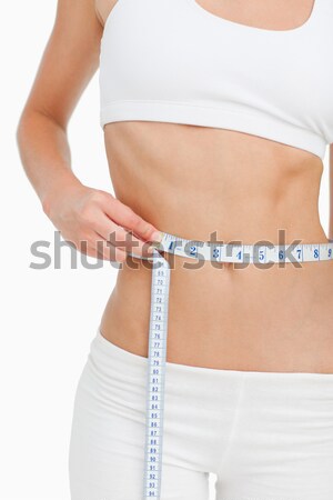Slim woman measuring thigh with tape measure Stock photo © wavebreak_media