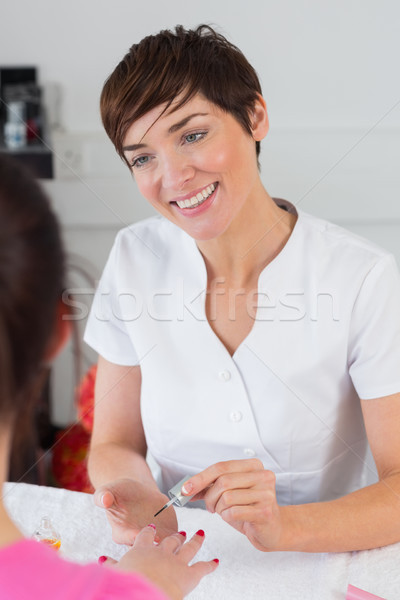 Close-up of woman applying nail varnish to finger nails Stock photo © wavebreak_media
