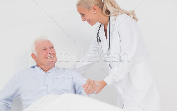 Doctor helping elderly man to sit up Stock photo © wavebreak_media