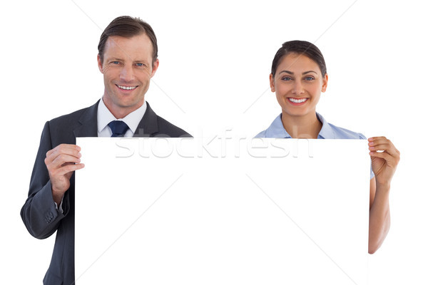 Smiling co workers holding a blank copy space Stock photo © wavebreak_media