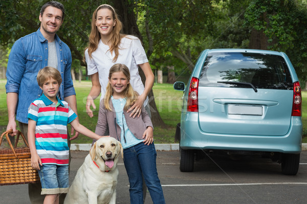 Happy family of four with car at picnic Stock photo © wavebreak_media