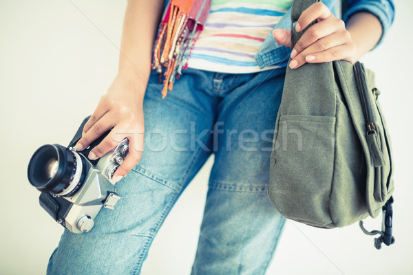 Stock photo: Woman in denim holding camera and shoulder bag
