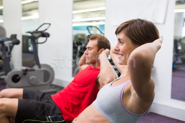 Stock photo: Fit couple doing sit ups on exercise ball
