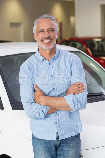 Stock photo: Smiling customer leaning on car with arms crossed