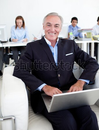 Smiling businessman using his laptop Stock photo © wavebreak_media