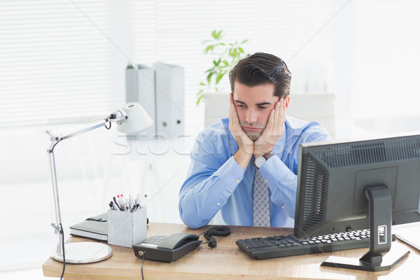 Sad businessman sitting at his desk Stock photo © wavebreak_media