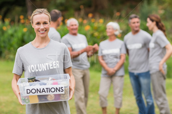 Happy volunteer holding donation box  Stock photo © wavebreak_media