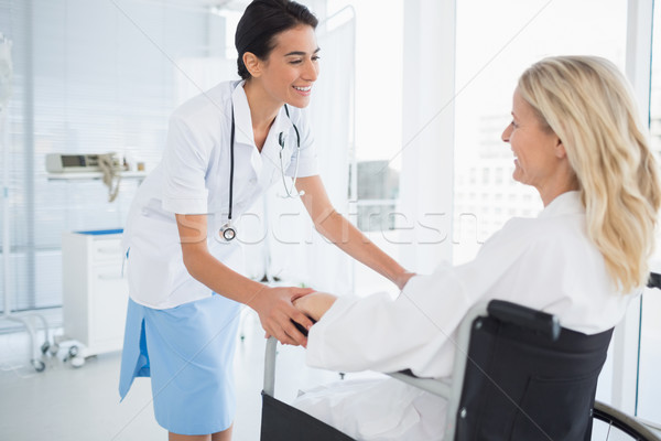 Happy doctor smiling at her patient in wheelchair  Stock photo © wavebreak_media