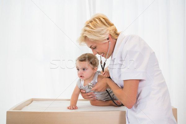 Blonde doctor with child and stethoscope  Stock photo © wavebreak_media