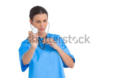 Stock photo: Pretty brunette thinking with finger on chin 