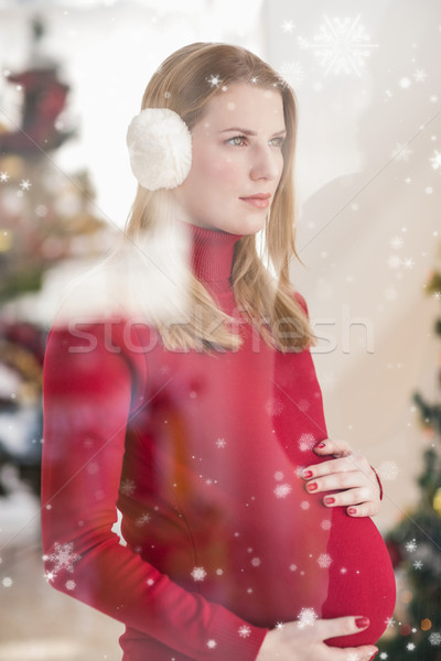 Composite image of pretty pregnant woman caressing her belly while standing Stock photo © wavebreak_media