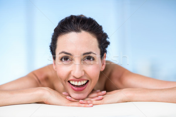 Smiling brunette relaxing on massage table Stock photo © wavebreak_media