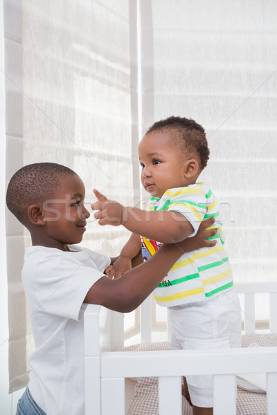 Babyboy playing with his brother in his bed Stock photo © wavebreak_media