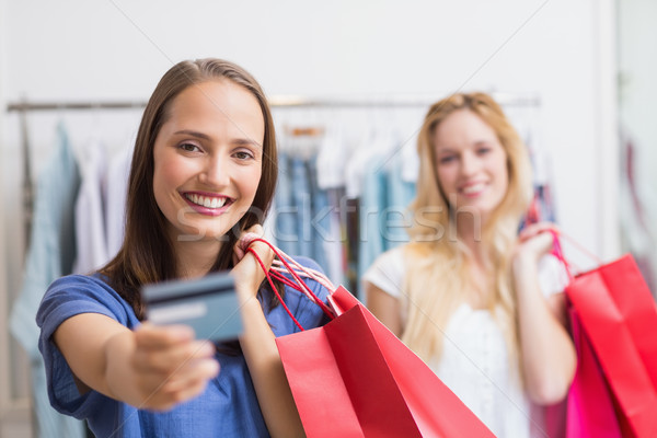 Happy friends handing a credit card Stock photo © wavebreak_media