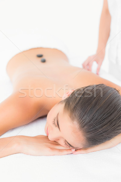Stock photo: Beautiful brunette enjoying a hot stone massage 