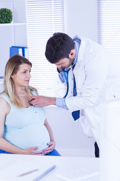 Doctor examining chest of pregnant patient Stock photo © wavebreak_media