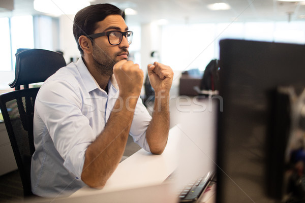 Thoughtful businessman sitting at desk Stock photo © wavebreak_media