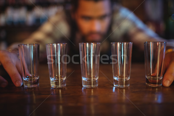 Waiter placing shot glasses on counter Stock photo © wavebreak_media