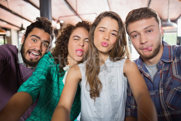 Stock photo: Friends making face in restaurant