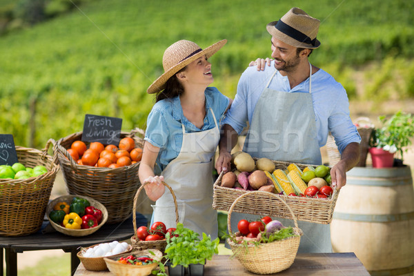 Happy couple standing by fresh fruits and vegetables Stock photo © wavebreak_media