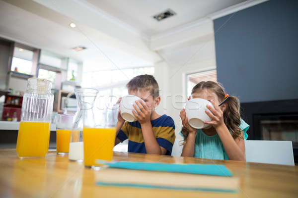 Sibling having breakfast cereal in kitchen Stock photo © wavebreak_media