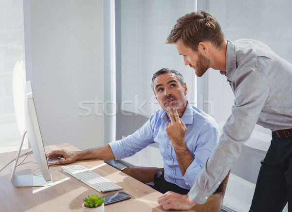 Executives interacting while working at desk Stock photo © wavebreak_media