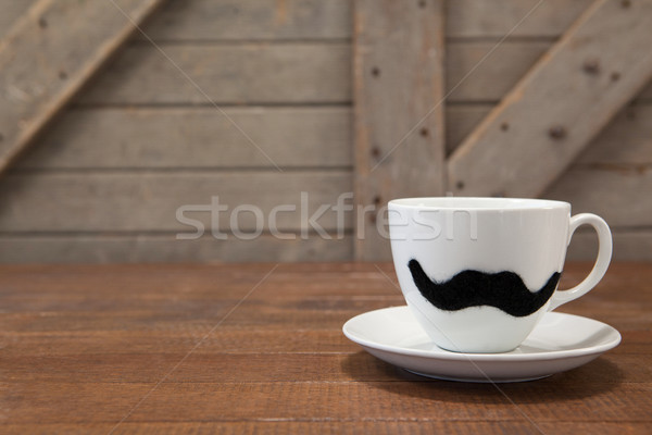 Coffee cup with mustache on table Stock photo © wavebreak_media