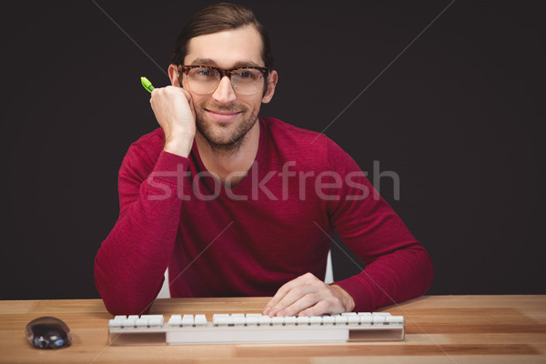 Portrait of confident man sitting at desk Stock photo © wavebreak_media