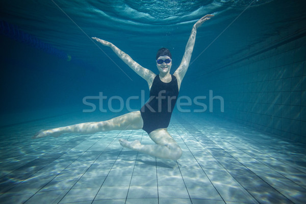 Pretty woman stretching underwater Stock photo © wavebreak_media