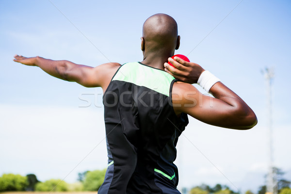 Stock photo: Male athlete preparing to throw shot put ball