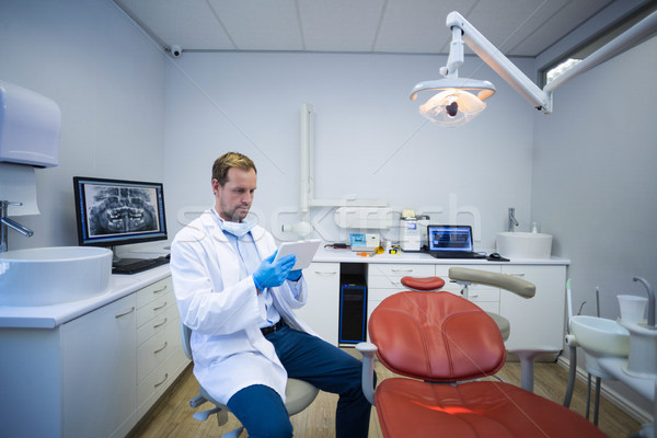 Doctor using digital tablet in dental clinic Stock photo © wavebreak_media