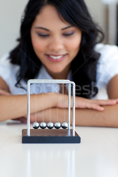 Businesswoman playing with kinetic balls Stock photo © wavebreak_media