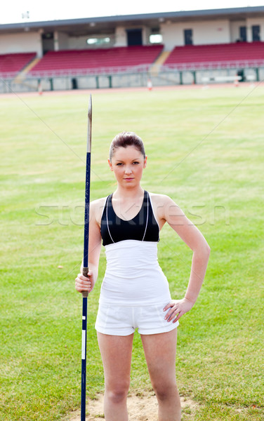confident athletic woman ready to throw a javelin standing in a stadium looking at the camera Stock photo © wavebreak_media