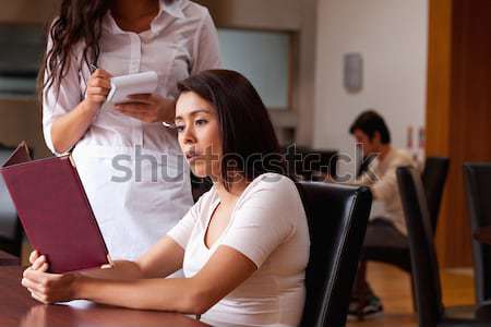 Portrait of a woman combing the hair of a customer standing up Stock photo © wavebreak_media