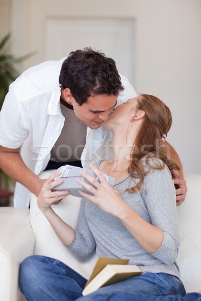 Young woman giving her boyfriend a small kiss as thanks for a present Stock photo © wavebreak_media