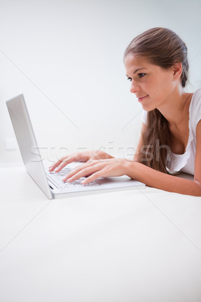 Young woman typing on her laptop Stock photo © wavebreak_media