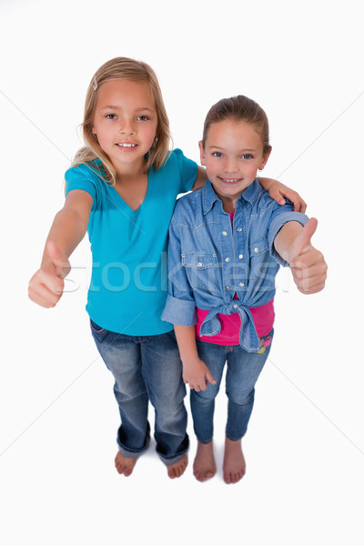 Stock photo: Portrait of girls with the thumbs up against a white background