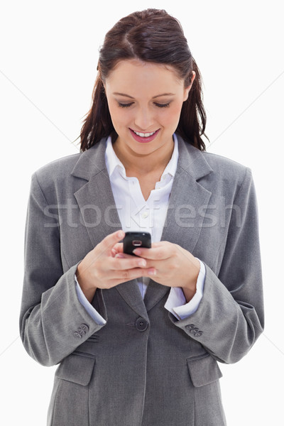 Close-up of a businesswoman smiling and watching her phone against white background Stock photo © wavebreak_media