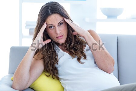 A woman lying at the end of the bed under the quilt looking to the side.  Stock photo © wavebreak_media