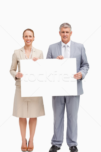 Business people smiling while holding a poster against white background Stock photo © wavebreak_media