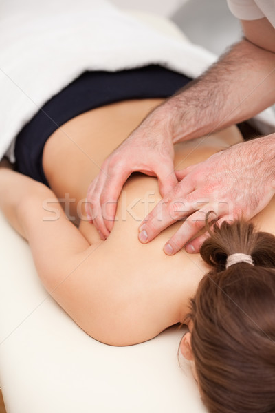 Woman lying on the table while being massaged in a room Stock photo © wavebreak_media