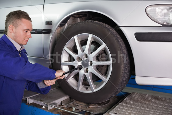 Mechanic unscrewing a bolt in a garage Stock photo © wavebreak_media