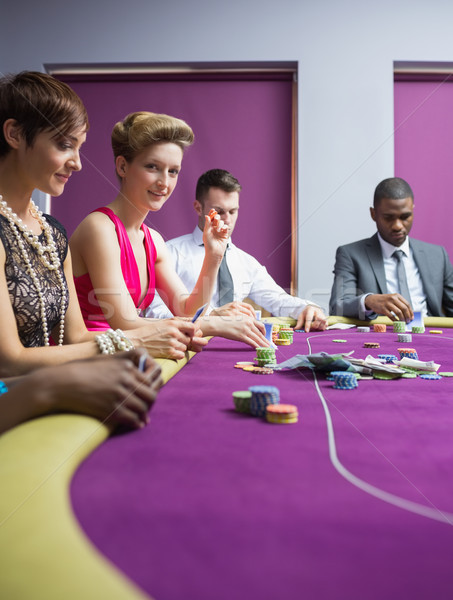 Woman smiling and looking up from poker game in casino Stock photo © wavebreak_media