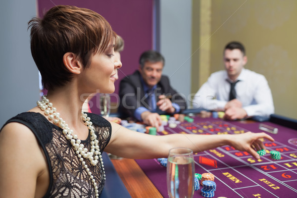 Woman sitting and placing a bet Stock photo © wavebreak_media