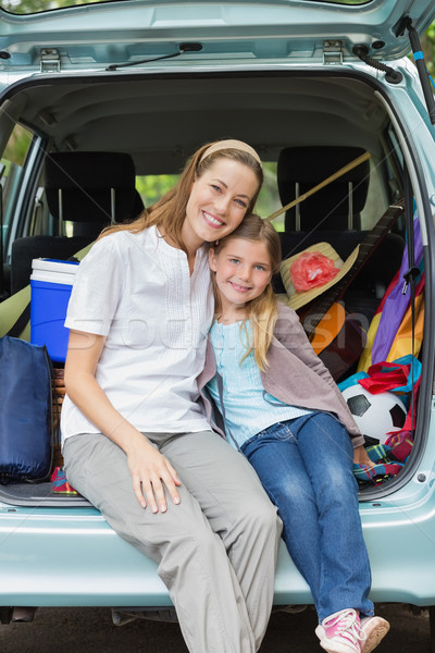 Smiling mother and daughter sitting in car trunk Stock photo © wavebreak_media