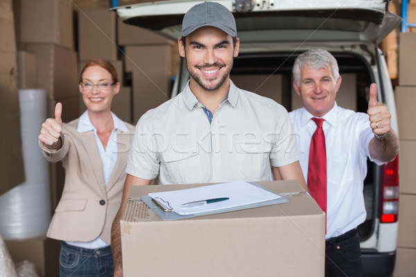 Warehouse managers and delivery driver smiling at camera Stock photo © wavebreak_media