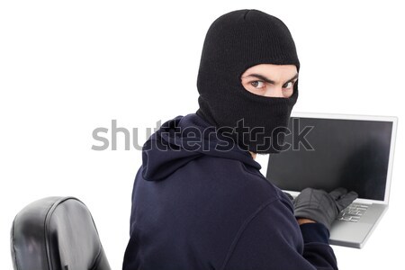 Hacker sitting and hacking laptop  Stock photo © wavebreak_media