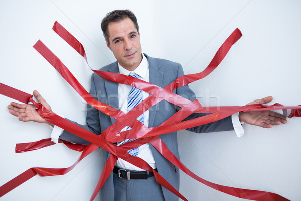 Businessman trapped by red tape Stock photo © wavebreak_media